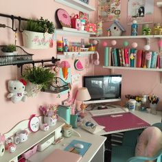 a desk with a computer on top of it in a room filled with toys and decorations