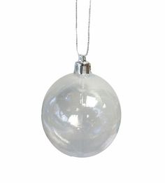 a white glass ornament hanging from a silver chain on a white background with clippings