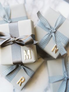 two wrapped presents with the letter m on them