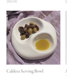 olives and oil in a white bowl on a purple cloth