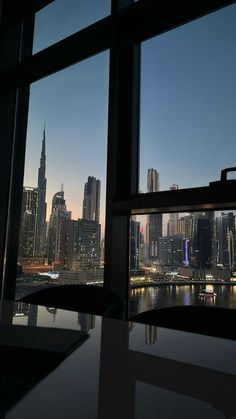 the city skyline is seen through large windows