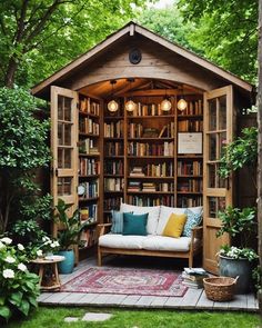 an outdoor room with a couch and bookshelf in the middle of it, surrounded by greenery