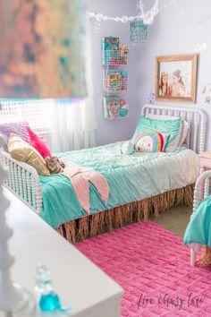 a bedroom with two twin beds and pink rugs