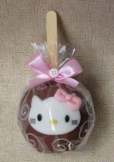 an image of a hello kitty ornament in the shape of a ball with a bow on it