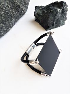 "Women's black square bracelet, black metal sharp cuff bracelet, edgy-rock style bracelet, geometric black jewelry, statement cuff, women's gift Welcome to my shop! ✈️ DHL EXPRESS SHIPPING AVAILABLE, 1-3 BUSINESS DAYS DELIVERY! ✔️ PLEASE MAKE SURE TO SELECT IT, RIGHT BEFORE YOUR PURCHASE! ❗️ ❗️ DON'T FORGET TO ADD YOUR CELL # AT THE \"NOTE TO SELLER\" SECTION IF YOU CHOOSE DHL! BY FILLING YOUR CELL NUMBER YOU EARN THE BENEFIT TO CHOOSE BETWEEN 6 DIFFERENT DELIVERY OPTIONS! INSTRUCTIONS WILL BE S Black Metal Cuff Bracelet For Gift, Black Metal Cuff Bracelet As Gift, Modern Black Metal Bracelets, Modern Black Rectangular Leather Bracelet, Modern Metal Jewelry With Black Band, Edgy Black Metal Cuff Bracelet, Minimalist Black Bracelet Jewelry, Adjustable Matte Black Modern Jewelry, Modern Adjustable Black Jewelry