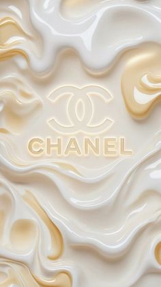 the word chanel is written in gold and white swirls on a cream colored background