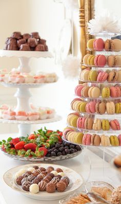 a table topped with lots of desserts and pastries