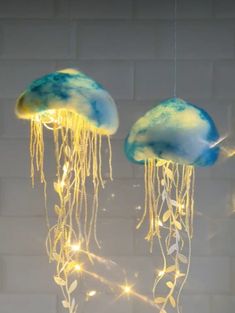 two blue and yellow jellyfish lights hanging from strings