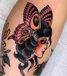 a woman with a butterfly tattoo on her arm and leg, next to a flower