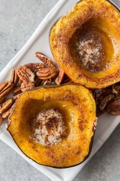 two acorns on a plate with pecans and cinnamon