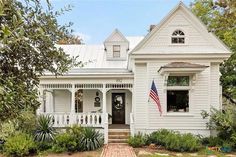 a white house with an american flag on the front door