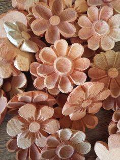 some very pretty pink flowers on a wooden table