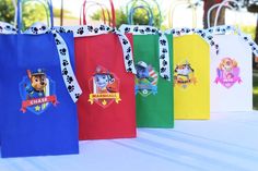 there are many bags that have paw patrol characters on them, all in different colors