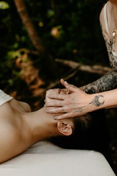 closeup of hands giving a woman with long black hair a facial massage. she is laying on a massage table in a river Massage Photo Ideas, Reiki Aesthetic Photography, Reiki Photoshoot Ideas, Spiritual Healer Photoshoot, Massage Branding Photoshoot, Energy Healer Photoshoot, Curandera Aesthetic, Incense Photoshoot, Massage Therapist Branding Photoshoot