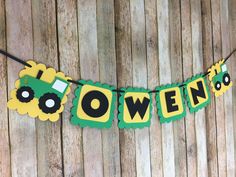 a green and yellow banner that says,'halloween'with two tractors on it