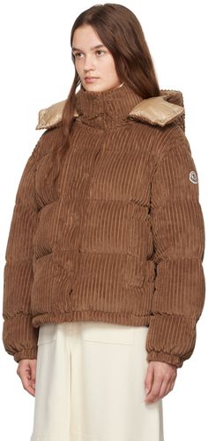 DIST-certified down-filled and quilted polyester corduroy jacket. · Detachable hood with press-stud throat guard · Funnel neck · Press-stud closure · Bungee-style drawstring at hem · Press-stud welt pockets · Tricolor felted logo patch at sleeve · Elasticized cuffs · Full longue saison lining Supplier color: Brown Fill: 90% down, 10% feather. Luxury Hooded Quilted Jacket For Winter, Luxury Hooded Quilted Winter Jacket, Moncler Jacket, Corduroy Jacket, Detachable Hood, Funnel Neck, Padded Jacket, Welt Pockets, Funnel