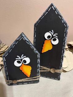 two black bird houses with faces painted on them and the words watch the entire video and more at