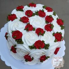 a cake with white and red roses on it