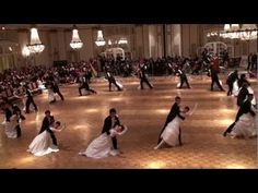 a group of people dancing in a large room