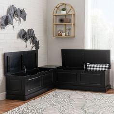 a living room with black furniture and white walls