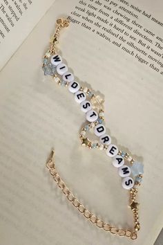 an open book with some beads on it and a chain attached to the front cover