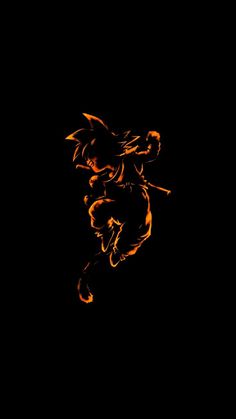 the silhouette of a demon on fire against a black background