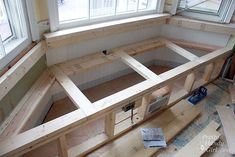 the inside of a house being built with windows and wooden flooring in place for insulation