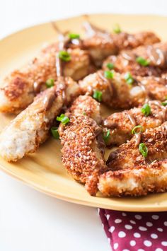 some fried food is on a yellow plate