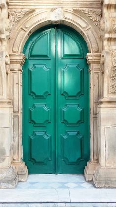 a large green door is open on a building