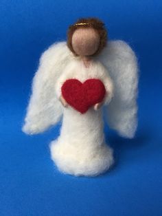 an angel holding a heart on a blue background