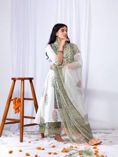 This suit set comes with a double dori neck detailing and a front long panel with borders. Pair it with a matching palazzo and hand-block printed dupatta for a complete elegant look this summer. 100% Premium Cotton Printed Suit Set Hand-block Printed Dupatta Comfort fit Set Contents: 1 Kurta, 1 Dupatta, 1 Palazzo Model height is 5.7 feet and is wearing size M Wash Care Instructions: Dry Clean Only Note: The product will be delivered within 15-20 days of the order placed. The product can be made Chanderi Straight Kurta Sharara With Printed Motifs, Chanderi Sharara With Printed Motifs, Cotton Silk Sharara With Printed Motifs, Straight Kurta Cotton Silk Lawn Suit With Printed Motifs, Bohemian Lawn Suit With Sheer Dupatta And Straight Kurta, Bollywood Style Palazzo Set With Printed Motifs, Cotton Silk Palazzo Set With Printed Motifs For Navratri, Traditional Palazzo Set With Printed Motifs And Straight Kurta, Cotton Silk Palazzo Set With Printed Motifs