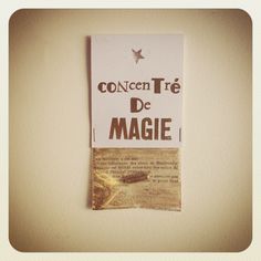 a piece of paper taped to the side of a wall that says confect tire de magic