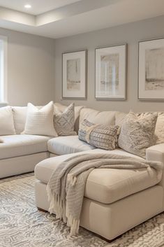 a living room filled with furniture and pillows on top of a white flooring area