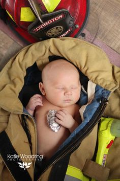 a baby is in a fireman's jacket