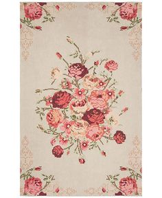 an area rug with flowers and leaves on the side, in pinks and browns