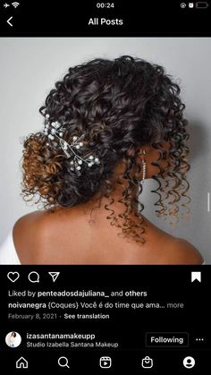 the back of a woman's head, with curly hair and pearls on it