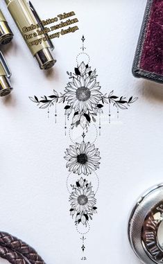 a cross with sunflowers on it and some writing next to it in black ink