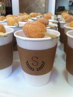 several cups with donuts in them are lined up on a table and ready to be eaten