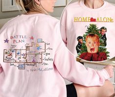 two women wearing pink sweatshirts with pictures on them