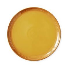 an empty yellow plate on a white background