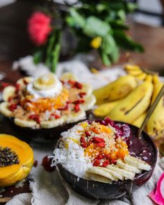 there are many different types of food in the bowl on the table, including bananas and other foods