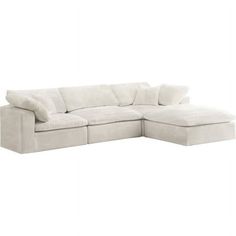 a white sectional couch with pillows on it's back and the seat folded out