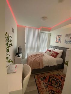 a bed sitting next to a window in a room with a rug on the floor