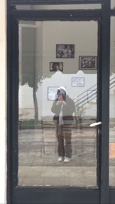 a person taking a photo through a glass door