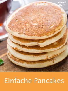 a stack of pancakes sitting on top of a wooden cutting board