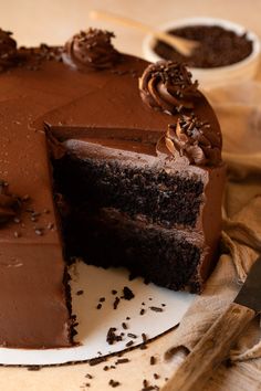 a piece of chocolate cake sitting on top of a green plate