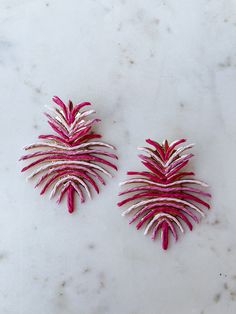 Add a tropical touch to your style with the Treasure Jewels Palm Paradise Earrings in pink. These handmade raffia earrings feature shades of pink and gold metallic accents. Perfect for adding a pop of color and fun to any outfit. Let your earrings do the talking! Length: 3in Post with backing Handmade Raffia Earrings, Shades Of Pink, Metallic Accents, Pink And Gold, Gold Metal, Color Pop, Paradise, Shades, Pink