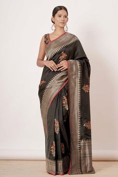 Black banarasi silk saree with big floral buttas all over and thick intricate border. Comes with blouse with all over butta in brocade with edging embroidery.
Component: 2
Pattern: Woven
Type Of Work: Floral Motifs
Neckline: Scoop
Sleeve Type: Sleeveless
Fabric: Pure Banarasi Silk, Brocade, Lining: Cotton/Shantoon
Color: Black
Other Details: 
Handwoven
Floral motifs
Back scoop neck blouse
Occasion: Reception - Aza Fashions Edging Embroidery, Big Floral, Floral Saree, Brocade Blouse, Black Pure, Brocade Blouses, Banarasi Silk Saree, Scoop Neck Blouses, Black Saree