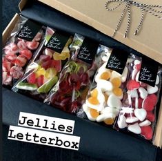 a box filled with assorted candies next to a sign that says jellies letterbox