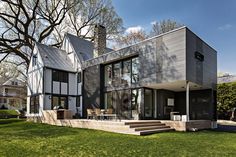 this modern house has large windows and is surrounded by grass